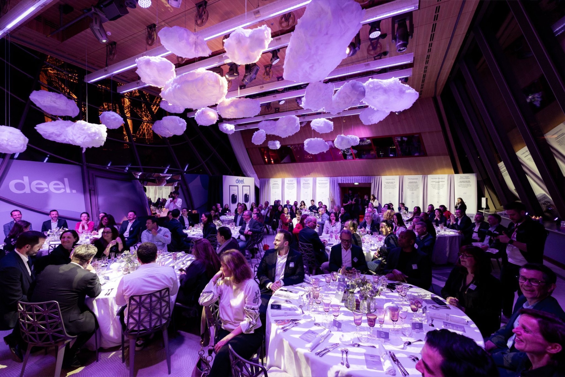 Dinner tables under suspended cloud installations inside Salon Gustave Eiffel, Eiffel Tower